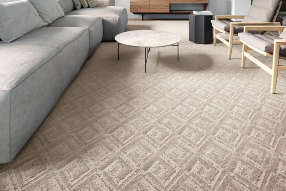 Beige geometric patterned carpet in living room.